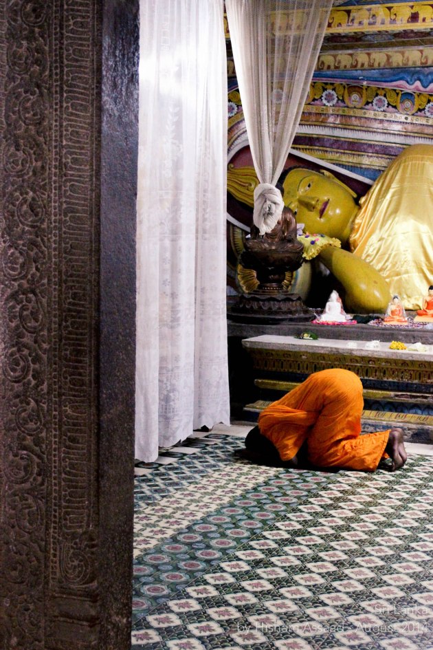 A praying monk - Inside the Temple of the Sacred Tooth